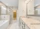 Luxurious bathroom boasting a soaking tub, glass-enclosed shower, and granite countertops at 5087 Sundrop Ln., Little River, SC 29566