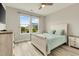 Comfortable bedroom with neutral paint, wood floors, and view of yard at 5087 Sundrop Ln., Little River, SC 29566