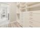 Organized walk-in closet featuring custom built-in shelving and drawers with easy access to the main bathroom at 5087 Sundrop Ln., Little River, SC 29566