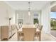 Elegant dining room filled with natural light, showcasing a modern chandelier and sliding glass doors at 5087 Sundrop Ln., Little River, SC 29566