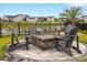 Backyard featuring a custom stone fire pit surrounded by Adirondack chairs overlooking the lake at 5087 Sundrop Ln., Little River, SC 29566
