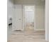 Hallway view showing access to bedroom and bathroom, as well as wood flooring at 5087 Sundrop Ln., Little River, SC 29566
