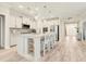 Bright kitchen boasts white cabinetry, a spacious island with seating, and modern stainless steel appliances at 5087 Sundrop Ln., Little River, SC 29566