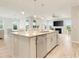 Open-concept kitchen features a central island with stainless steel dishwasher, sink, and plenty of counter space at 5087 Sundrop Ln., Little River, SC 29566