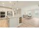 Spacious kitchen featuring stainless steel appliances, an island, and a dining area at 5087 Sundrop Ln., Little River, SC 29566