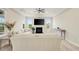 Cozy living room featuring a tray ceiling, fireplace, and a comfortable sofa at 5087 Sundrop Ln., Little River, SC 29566
