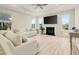 Bright and airy living room with a fireplace, large windows, and comfortable seating at 5087 Sundrop Ln., Little River, SC 29566