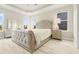 Spacious main bedroom features a tray ceiling, ample natural light, and stylish decor at 5087 Sundrop Ln., Little River, SC 29566