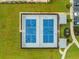 An aerial shot reveals pickle ball courts surrounded by lush landscaping and ample parking at 5087 Sundrop Ln., Little River, SC 29566