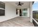 Relaxing screened-in porch with tile flooring and ceiling fan, with easy access to the dining room at 5087 Sundrop Ln., Little River, SC 29566