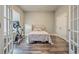 Cozy bedroom features modern dark wood floors, a stationary bike, and great natural light at 520 Oak Pond Ct., Conway, SC 29526