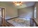 Bedroom boasts a ceiling fan, hardwood flooring, and an oversized area rug with a beautiful pattern at 520 Oak Pond Ct., Conway, SC 29526