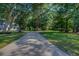 A beautiful long driveway with large trees lining either side, leading to a well-maintained home at 520 Oak Pond Ct., Conway, SC 29526