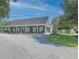Exterior view of a one story commercial building with green siding, white trim, and a parking lot at 520 Oak Pond Ct., Conway, SC 29526