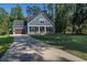 Charming two-story home featuring a welcoming front porch, a well-manicured lawn, and a long driveway at 520 Oak Pond Ct., Conway, SC 29526