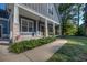 Inviting front porch features stone-clad columns, lush plants, and a walkway leading to the entrance at 520 Oak Pond Ct., Conway, SC 29526