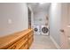 Bright laundry room with new washer and dryer and a custom-built wooden storage cabinet at 520 Oak Pond Ct., Conway, SC 29526