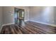 Well-lit living room features dark wood floors, neutral walls, and an open doorway at 520 Oak Pond Ct., Conway, SC 29526