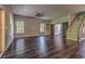 Expansive living room featuring beautiful wood floors, large windows, and a sliding barn door at 520 Oak Pond Ct., Conway, SC 29526
