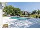 Community pool with lounge chairs, tables, umbrellas and views of the neighborhood homes at 520 Oak Pond Ct., Conway, SC 29526