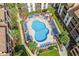 Aerial shot of large pool with sun loungers surrounded by palms and residences at 5515 N Ocean Blvd. N # 206, Myrtle Beach, SC 29577
