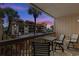 Balcony with chairs offers beautiful views of the pool, beach, and twilight sky at 5515 N Ocean Blvd. N # 206, Myrtle Beach, SC 29577