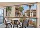 Relaxing balcony with seating and views of palm trees and the complex at 5515 N Ocean Blvd. N # 206, Myrtle Beach, SC 29577