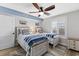 Comfortable bedroom with two beds, blue accents, and natural light from a window at 5515 N Ocean Blvd. N # 206, Myrtle Beach, SC 29577