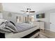 Relaxing bedroom with a ceiling fan, TV, and balcony access at 5515 N Ocean Blvd. N # 206, Myrtle Beach, SC 29577