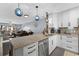 Bright kitchen features granite counters, stainless appliances, and unique lighting at 5515 N Ocean Blvd. N # 206, Myrtle Beach, SC 29577