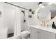 Well-lit bathroom featuring sleek white tiling, a vanity with a gold faucet, and a glass-enclosed shower at 5523 N Ocean Blvd. # 2006, Myrtle Beach, SC 29577