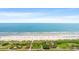 An aerial view of the beautiful beach featuring white sand, clear blue waters, and lush greenery at 5523 N Ocean Blvd. # 2006, Myrtle Beach, SC 29577