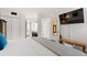 A serene bedroom with white walls and light wood floors featuring a TV and ensuite bath and closet at 5523 N Ocean Blvd. # 2006, Myrtle Beach, SC 29577