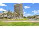 High-rise condo building with lush landscaping and a view of the street at 5523 N Ocean Blvd. # 2006, Myrtle Beach, SC 29577