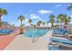 Resort-style outdoor pool surrounded by palm trees and lounge chairs, perfect for relaxation and sunbathing at 5523 N Ocean Blvd. # 2006, Myrtle Beach, SC 29577