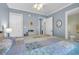 This cozy bedroom includes a charming bed with a blue paisley quilt and access to the bathroom at 6001 - Q21 South Kings Hwy., Myrtle Beach, SC 29575