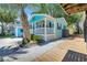 A charming beach cottage with blue siding, front porch, and lush landscaping at 6001 - Q21 South Kings Hwy., Myrtle Beach, SC 29575