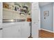 Convenient laundry room with modern washer and dryer, and plenty of storage shelves for organization at 6001 - Q21 South Kings Hwy., Myrtle Beach, SC 29575
