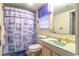 Cozy bathroom featuring a blue sink, toilet, and a charming lighthouse-themed shower curtain at 609 3Rd Ave. N, Myrtle Beach, SC 29577