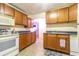 Functional kitchen with wood cabinets, white appliances, and tiled flooring, offering ample counter space at 609 3Rd Ave. N, Myrtle Beach, SC 29577