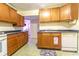 Efficient kitchen with wood cabinetry, white appliances, and tiled flooring for easy maintenance at 609 3Rd Ave. N, Myrtle Beach, SC 29577