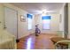 Entry way to a sunlit room with hardwood floors; features windows with blue trim and simple decor at 609 3Rd Ave. N, Myrtle Beach, SC 29577