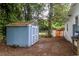 Backyard with a blue and white shed surrounded by trees and greenery at 609 3Rd Ave. N, Myrtle Beach, SC 29577