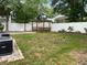 Fenced backyard with a wooden pergola and brick patio at 618 Cypress Dr., Surfside Beach, SC 29575