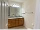Bathroom featuring double sinks, wood cabinets, and a large mirror at 618 Cypress Dr., Surfside Beach, SC 29575
