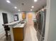 Galley kitchen with stainless steel appliances and tiled floors and granite countertop bar at 618 Cypress Dr., Surfside Beach, SC 29575