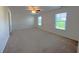 Bedroom with neutral carpet, two windows and a ceiling fan at 6619 Colonial Dr., Myrtle Beach, SC 29572