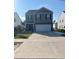 A two-story house with green siding and a two car garage at 6619 Colonial Dr., Myrtle Beach, SC 29572