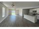 Open concept living room with lots of light, ceiling fan and view into the kitchen at 6619 Colonial Dr., Myrtle Beach, SC 29572