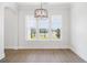 Bright dining room featuring hardwood floors, ample natural light, and a stylish chandelier at 6850 Belancino Blvd., Myrtle Beach, SC 29579